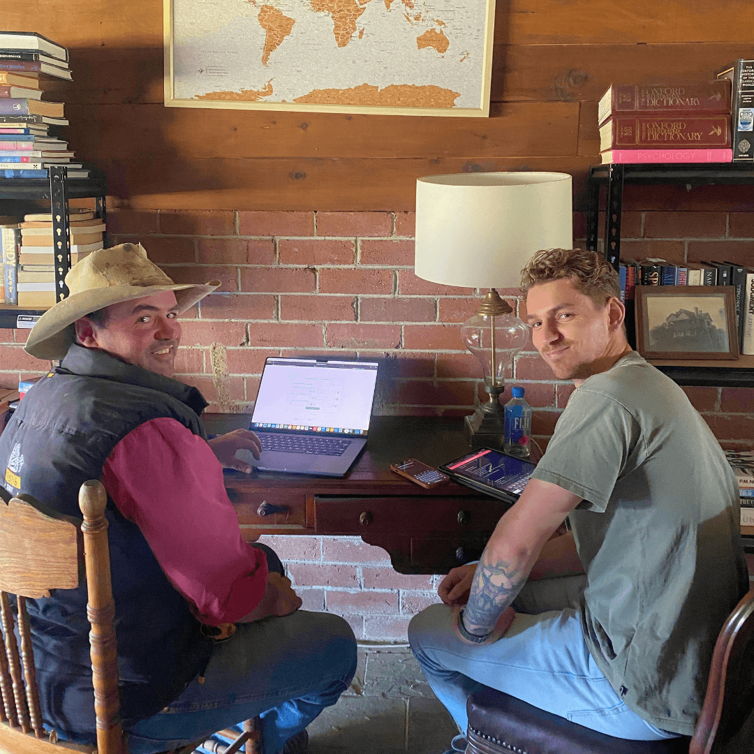 A farmer with Ruminati tech support entering farm data into the platform at the Ruminati producer day.