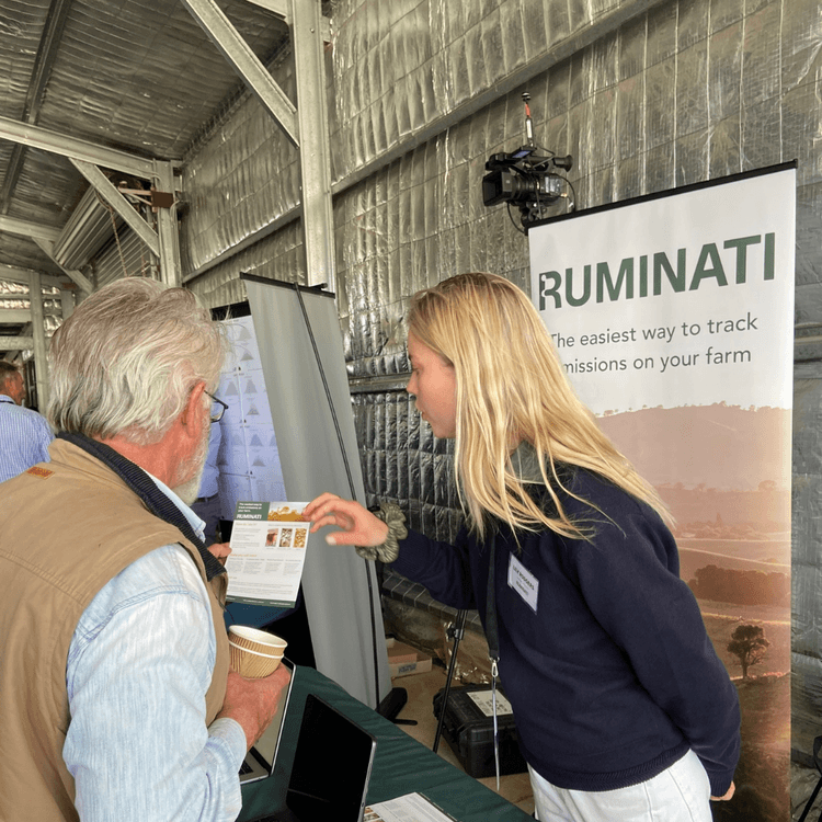 Ruminati Customer Success Lead Lily Rodgers explains emissions reporting benefits to a producer at the Wilmot Field Day.