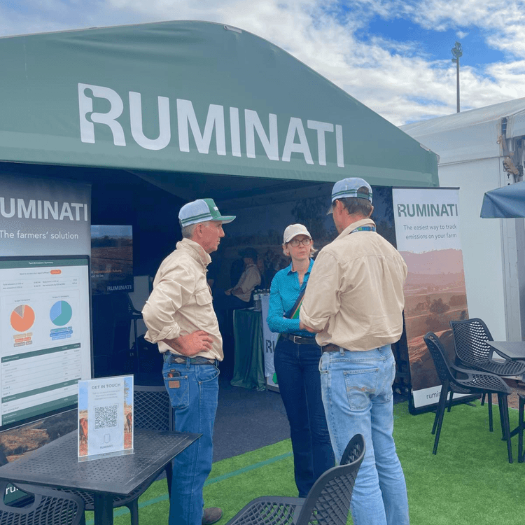 Bill Findlay and Will Onus talk to a cattle producer out the front of the Ruminati tent at Beef 2024.